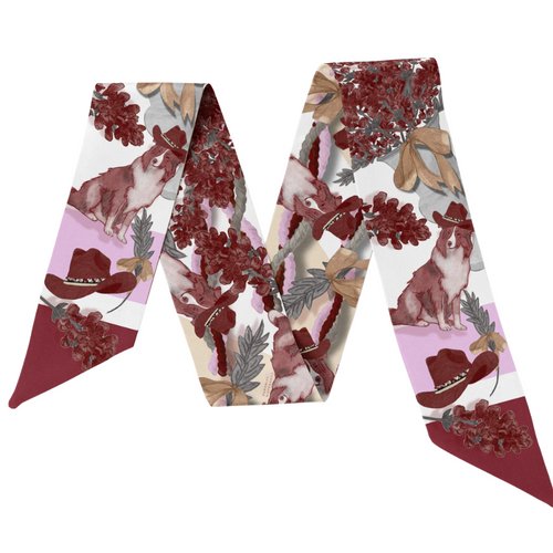 This vibrant scarflette is full of College Station charm and a whole lotta Aggie spirit! Featuring delicate florals in bold maroon and soft blush, it's sprinkled with playful pup silhouettes — a sweet nod to everyone's favorite mascot. Whether you're walking campus, heading to Kyle Field, or brunching on Northgate, this silky stunner is your new game day (and every day) essential.