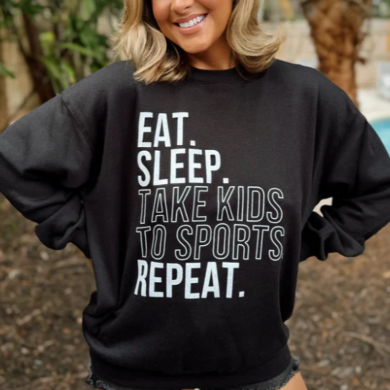 It's Game time and we love when comfy-meets-statement! Slip into a world of comfort in our EAT SLEEP TAKE KIDS TO SPORTS REPEAT, Cozy, Black Sweatshirt. It's the perfect blend of softness and warmth, making it a great option for cooler games day or night!