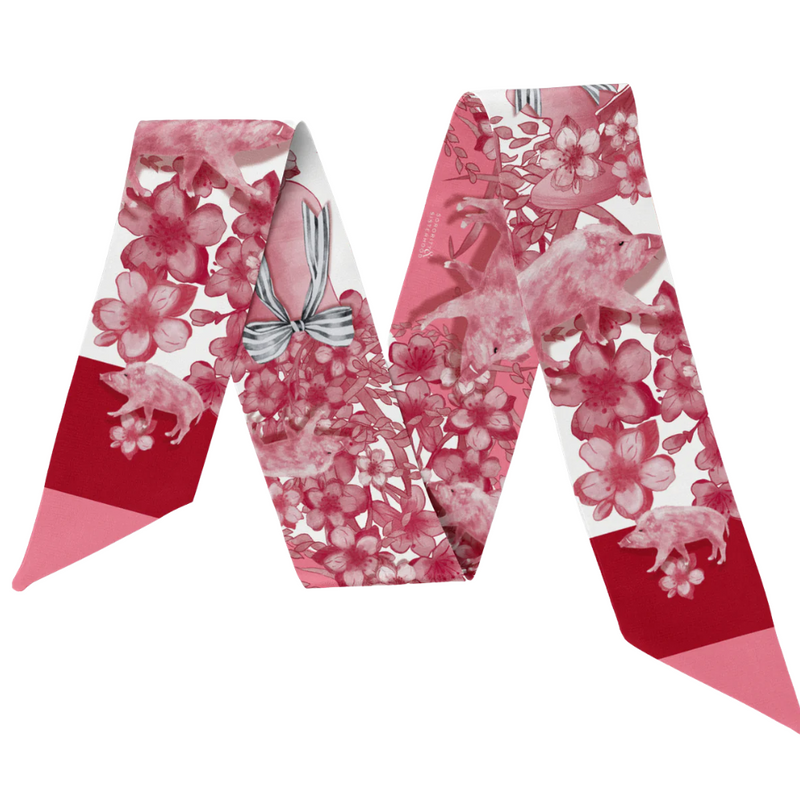 Calling all Razorback sweethearts!&nbsp;This Fayetteville-inspired scarflette is full of southern charm and hometown pride. With a soft floral pattern in shades of red and blush and adorable hog silhouettes tucked in the design, it’s a playful nod to everything we love about life on The Hill. Whether you’re strolling Dickson Street, tailgating at Donald W., or cheering&nbsp;Wooo Pig Sooie! with your crew, this silky little accessory brings the perfect pop of Fayetteville flair.