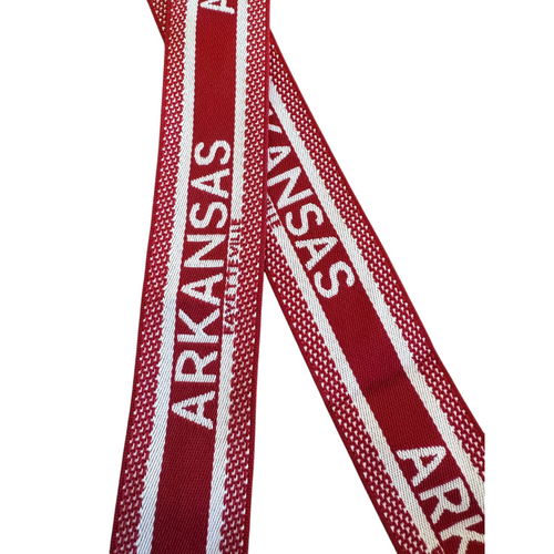 Add a splash of college spirit to your crossbody with the Fayettville, Arkansas canvas trap. Featuring a playful, designer-inspired pattern in vibrant red and white.. Made from a lightweight cotton/poly blend with chic gold hardware, it’s the perfect blend of style and comfort for game day or everyday fun.