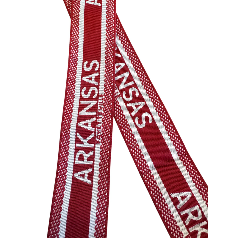 Add a splash of college spirit to your crossbody with the Fayettville, Arkansas canvas trap. Featuring a playful, designer-inspired pattern in vibrant red and white.. Made from a lightweight cotton/poly blend with chic gold hardware, it’s the perfect blend of style and comfort for game day or everyday fun.