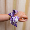 This scarflette brings big Fort Worth energy with a splash of Tarleton charm! Featuring soft floral details in bold shades of purple, it’s sprinkled with playful horse silhouettes — a sweet nod to the spirited Texan way of life. Whether you’re on campus, headed to a rodeo, or just reppin’ Purple Poo vibes around town, this silky accessory is your new go-to for adding that hometown sparkle.