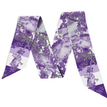 This scarflette brings big Fort Worth energy with a splash of Tarleton charm! Featuring soft floral details in bold shades of purple, it’s sprinkled with playful horse silhouettes — a sweet nod to the spirited Texan way of life. Whether you’re on campus, headed to a rodeo, or just reppin’ Purple Poo vibes around town, this silky accessory is your new go-to for adding that hometown sparkle.