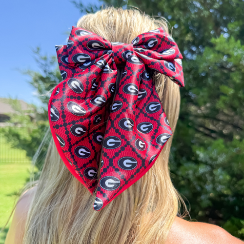 Add a splash of collegiate charm with our Satin Game Day Hair Bow. This playful accessory features a vibrant pattern that’s perfect for showing off your school pride. Whether for game day or everyday fun, this versatile hair bow brings a spirited touch to your collection.