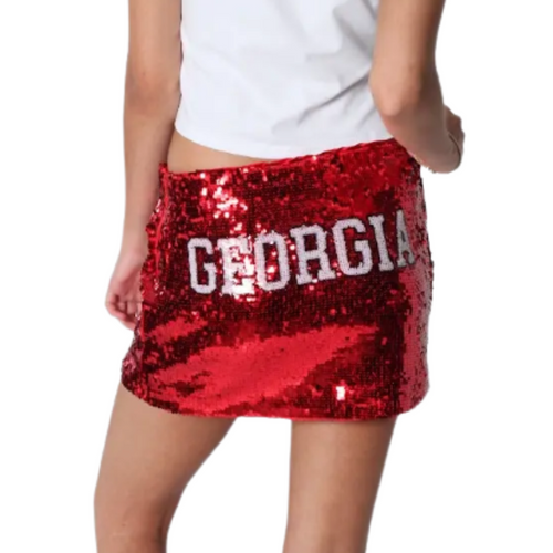 Sparkle louder with the Georgia Bulldogs Sequin Mini Skirt! This flirty mini skirt dazzles with shimmering sequins and a hint of stretch for comfort. Finished with your school name stitched across the back, it’s perfect for showing off your team spirit in style. Whether you’re cheering in the stands or heading out with friends, this skirt lets everyone know exactly who you’re rooting for.