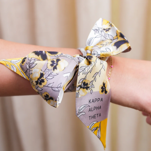 Flaunt your Theta spirit with this sassy silk scarflette that brings sorority chic to any ensemble! This fun accessory pops with Kappa Alpha Theta charm, making heads turn whether you're at brunch or a reunion. Gift it to your favorite sister or treat yourself – it's the playful way to showcase your Theta pride while keeping your fashion game strong!
