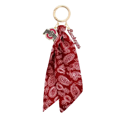 Bring the fun wherever you go with this game day-ready bag charm! Featuring a bold paisley-print bandana, shiny gold hardware, and sporty charm accents, it’s the ultimate way to show your spirit in style. Clip it to your bag, keys, or backpack and let the tailgate vibes follow you everywhere. Perfect for cheering, repping your team, or just adding a pop of personality to your look!