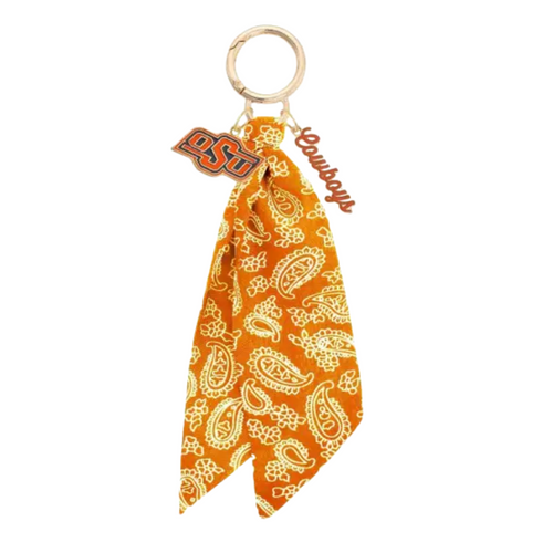 Bring the fun wherever you go with this game day-ready bag charm! Featuring a bold paisley-print bandana, shiny gold hardware, and sporty charm accents, it’s the ultimate way to show your spirit in style. Clip it to your bag, keys, or backpack and let the tailgate vibes follow you everywhere. Perfect for cheering, repping your team, or just adding a pop of personality to your look!