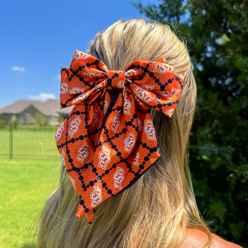 Add a splash of collegiate charm with our Satin Game Day Hair Bow. This playful accessory features a vibrant pattern that’s perfect for showing off your school pride. Whether for game day or everyday fun, this versatile hair bow brings a spirited touch to your collection.