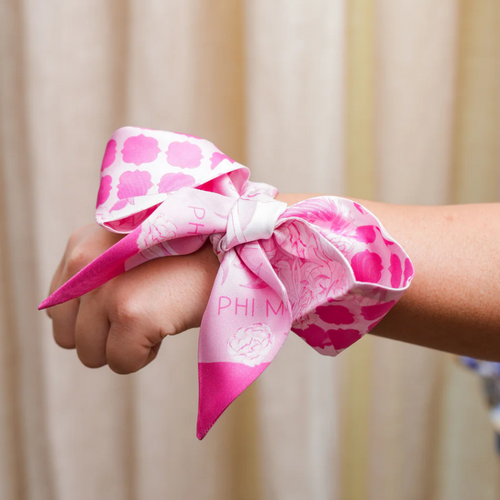 Display your Phi Mu pride with this playful silk scarflette! This versatile pink and white accessory adds a pop of sorority spirit to any outfit. Tie it on your bag, twist it in your hair, or rock it as a neck scarf – the possibilities are endless! Perfect for gifting to your favorite sister or treating yourself to a fun reminder of your Phi Mu bonds. This cute little piece of pink carnation flair is sure to spark conversations and sisterhood memories wherever you go!
