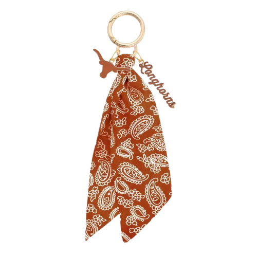 Bring the fun wherever you go with this game day-ready bag charm! Featuring a bold paisley-print bandana, shiny gold hardware, and sporty charm accents, it’s the ultimate way to show your spirit in style. Clip it to your bag, keys, or backpack and let the tailgate vibes follow you everywhere. Perfect for cheering, repping your team, or just adding a pop of personality to your look!