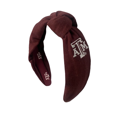 Show your Aggie pride with this playful linen headband featuring an embroidered Texas A&amp;M logo on the side and sublimated logos inside for a fun surprise. Comfortable and stylish, it’s perfect for game day or everyday wear.