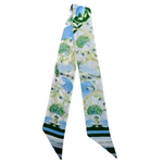 Green Wave glam, NOLA style 💚⚜️
This Tulane-inspired scarflette is full of charm, color, and Crescent City cool. With a delicate floral pattern in shades of green and blue and playful wave and fleur-de-lis accents, it’s a flirty nod to Uptown vibes and Green Wave pride. Whether you're heading to campus, parading down St. Charles, or cheering on the Wave at Yulman, this silky little accessory adds a dash of Tulane spirit to every look.

Crafted from luxe 100% silk twill, it's as versatile as it is vibrant —