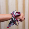 Sweet style from T-Town. This Tuscaloosa-inspired scarflette is all charm, all Crimson, and all about that Bama pride! With soft floral details in crimson and blush plus adorable elephant silhouettes tucked into the print, it’s a playful nod to the traditions and spirit of the Capstone. Whether you're heading to Bryant-Denny, strolling the Strip, or yelling Roll Tide! with your crew, this silky little accessory brings the perfect pop of T-Town flair.