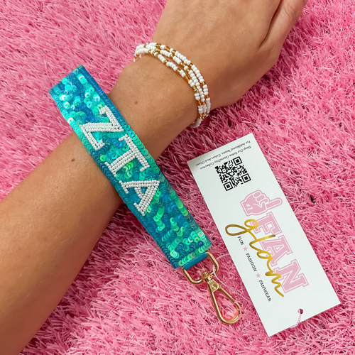 Greek Glam just dropped! This wristlet is serving sparkle, shine, and serious sorority energy — fully sequined and reppin’ your letters loud and proud.&nbsp;Whether you’re heading to chapter, running to class, or getting gift-ready for Bid Day or Big/Little, this piece brings the perfect pop of sorority style. Clip it on, show it off, and let your Greek girl era shine&nbsp;