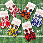 It's time to get ready for kick-off!  Show off your football fan status by accessorizing your Game Day look with our brand new team colored football stud earrings!   Available in 5 versatile color ways you can mix and match with all your stadium looks!