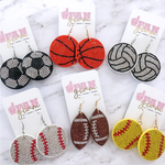 Show your love for the game when accessorizing your Game Day look with our sporty + chic sports ball rhinestone round dangle earrings.    Available in six sport options, they are the perfect accessory to coordinate with your Friday Night Lights ensemble or Saturday tailgate style.