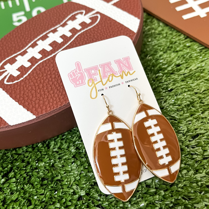 Show your love for the game when accessorizing your Game Day look with our sporty + chic enamel football earrings.    The perfect accessory to coordinate with your Friday Night Lights ensemble or Saturday tailgate style.