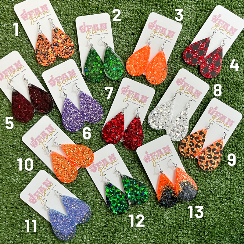 Our GameDay Glitter Glam Dangle earrings are the perfect combination of bright colors and fun prints!   Available in an array of team colors, you can pick and choose your favorite print, shape and design to elevate your GameDay glam. 