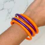 It's a good time to be Jelly...  Our new Game Day Jelly Bangles are the perfect pop of color to elevate your arm candy.  Level up your Game Day stack with a stack of 5 team colored sporty + chic jelly bracelets.  Mix and match with all your favorite team colors to create the perfect layering stack!