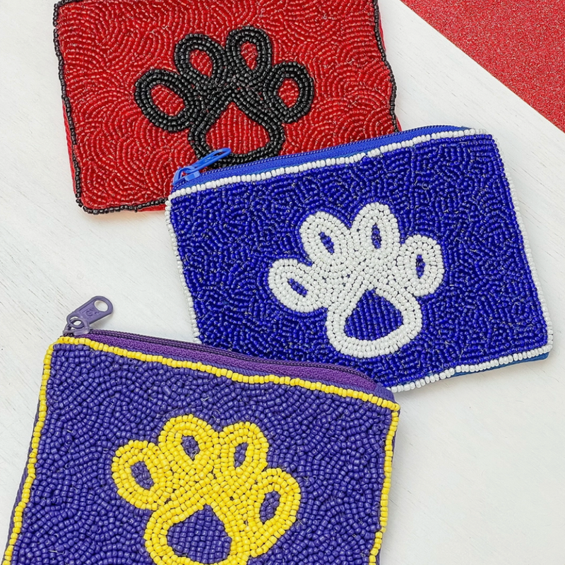 Our PUUR-Fect GAMEDAY accessory!  Elevate your clear bag status and showcase this adorable beaded paw print coin purse featuring three iconic team colors!  A perfect sized team colored pouch to fit your cash, credit card lipstick and keys