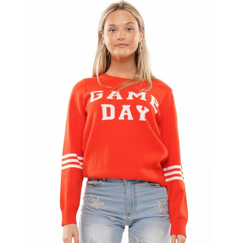 It's Game Time and we love when comfy-meets-statement!    Our Orange and white Gameday Sweater is that and more! This knit sweater features a high rounded neckline, jersey striped long sleeves, a slightly relaxed bodice, fitted cuffs, and a "GAME DAY" graphic on the chest. Tuck this one-of-a-kind sweater into your favorite bottoms or wear it atop a pair of Spanx leggings. Perfect for a cooler game day/night!