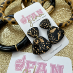 Our GameDay Tam Clay Co Black & Gold Fleck Collection features three fun new designs. It's the perfect ear candy for all your holiday get togethers and day-to-GameDay looks.  