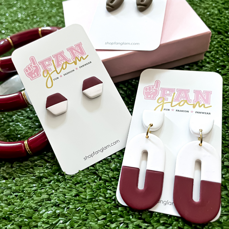 Our GameDay Tam Clay Co Maroon Collection features two fun collectable styles, it's the perfect way to add team color and a fun pop of color to your gameday attire.