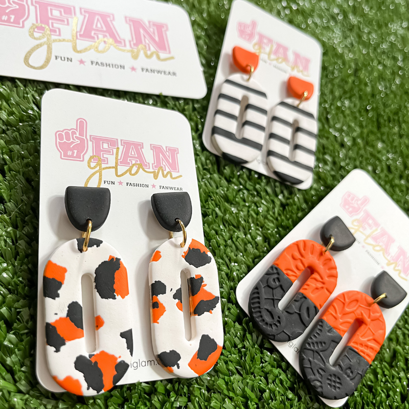 Our GameDay Tam Clay Co Orange Jana Collection features three fun collectable prints, it's the perfect way to add team color and a fun pop of print to your gameday attire.