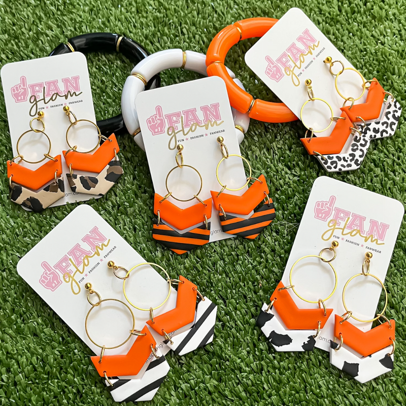 Our GameDay Tam Clay Co Orange Lori Chevron Collection features four fun collectable prints and it's the perfect way to add team color and a fun pop of print to your gameday attire.