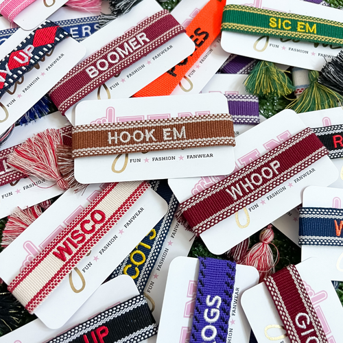 Your team. Your squad. Your identity.  Our new GameDay Team Tassels have arrived!   We've teamed up with Gameday Luxe to provide a high-end fashion driven add-on stack to take you from tailgate to postgame and everywhere in between!  
