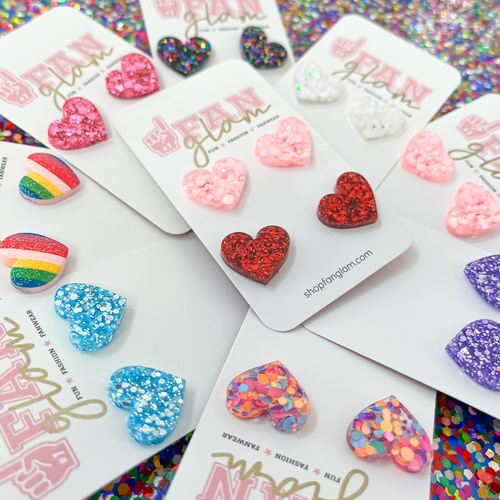 Love Is In The Air...  And our Glitter Glam Mini Heart Studs are the perfect pop of color + glam to help spread love to all your favorite humans this Valentine's!  A perfect gift for your bestie or your little one, its a versatile size that all ages can enjoy!  Super lightweight and comfortable, you will forget you have them on. Available in over a dozen fun colors, collect them all!