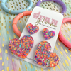 Love Is In The Air...  And our Glitter Glam Mini Heart Studs are the perfect pop of color + glam to help spread love to all your favorite humans this Valentine's!    A perfect gift for your bestie or your little one, its a versatile size that all ages can enjoy!  Super lightweight and comfortable, you will forget you have them on.