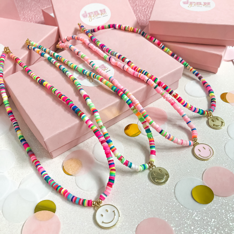Designed by and named after our very first GlamBassador Gabby!  We are excited to introduce our newest arrival - the Gabby Mini Heishi Smiley Face Charm Necklace.    It's a summer must-have and the PERFECT layering necklace to add a fun pop of color to all your favorite summer go-to's!  Available in 4 fun designs, it's a great layering piece, to start off your GameDay look!