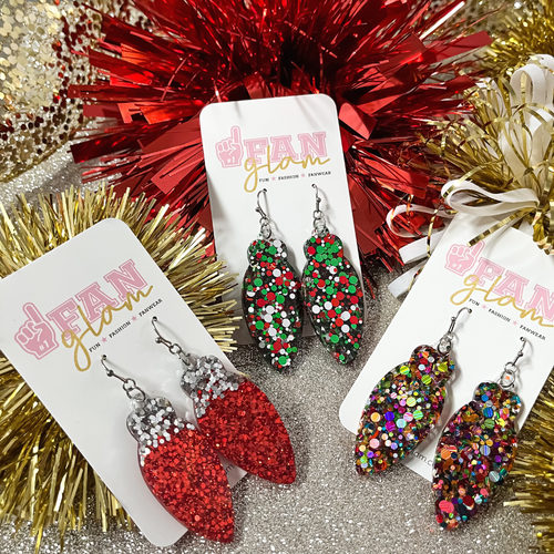 Our Holiday Glitter Glam Dangle earrings are the perfect combination of bright colors, fun prints, designs and holiday cheer!   Available in an array of colors and styles, you can pick and choose your favorites.  The perfect Secret Santa Gift all your besties!