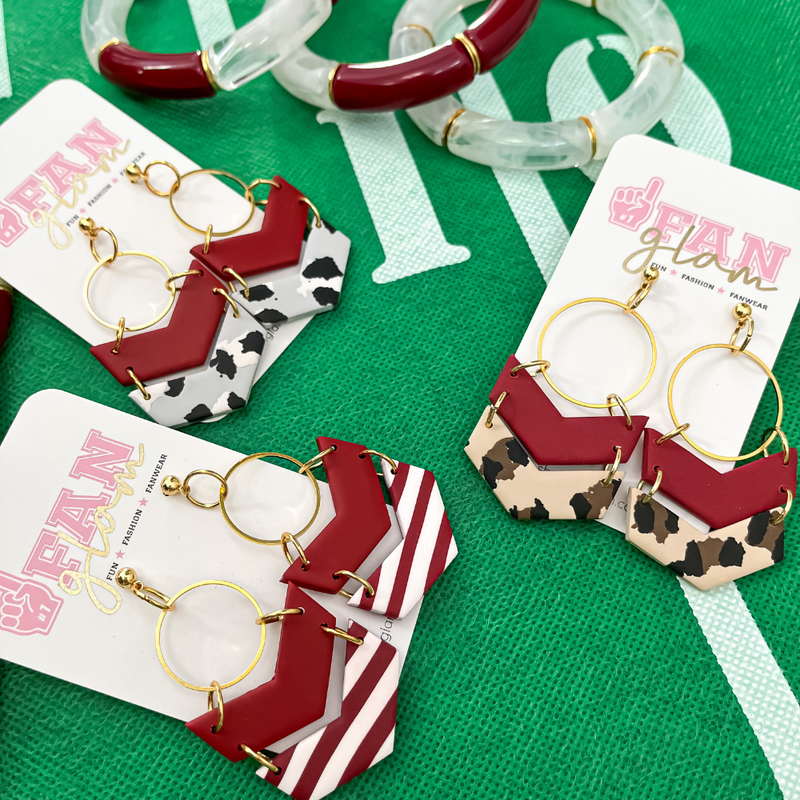 Our Gameday Tam Clay Co Lori Chevron earrings are available in three fun prints. Crimson and stripes Crimson and grey leopard and Crimson and tan leopard