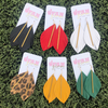 Add a little boho flair to your GameDay style when sporting these fabulous leather feather stunners.  Featuring a golden brass bar and available in six fun color ways.