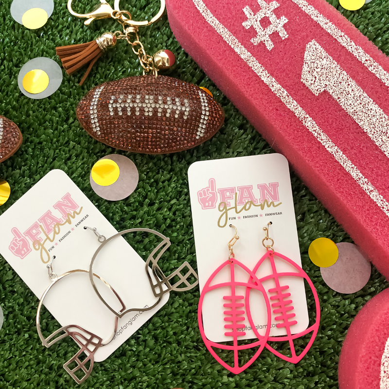 It's time to get ready for kick-off!  Show off your football fan status by accessorizing your Game Day look with our brand new Touchdown Football Drop Earrings.     Available in 6 versatile color ways you can mix and match with all your stadium looks!