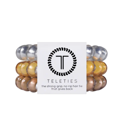TELETIES - MEDALLION  Hold your hair and enhance your style with TELETIES. The strong grip, no rip hair tie that doubles as a bracelet. Strong, pretty and stylish, TELETIES are designed to withstand everyday demands while taking your look to the next level.