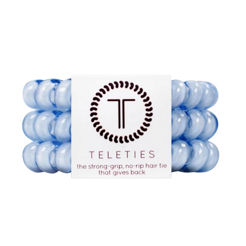 TELETIES - WASHED DENIM  Hold your hair and enhance your style with TELETIES. The strong grip, no rip hair tie that doubles as a bracelet. Strong, pretty and stylish, TELETIES are designed to withstand everyday demands while taking your look to the next level.