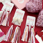 Let's give a BIG Shout Out to our Newest Arrival, our Valentine's Tinsel Pom Pom Fringe Earrings!! The perfect pop of color for Valentine's and a great way to add some festive flare to your game day attire!