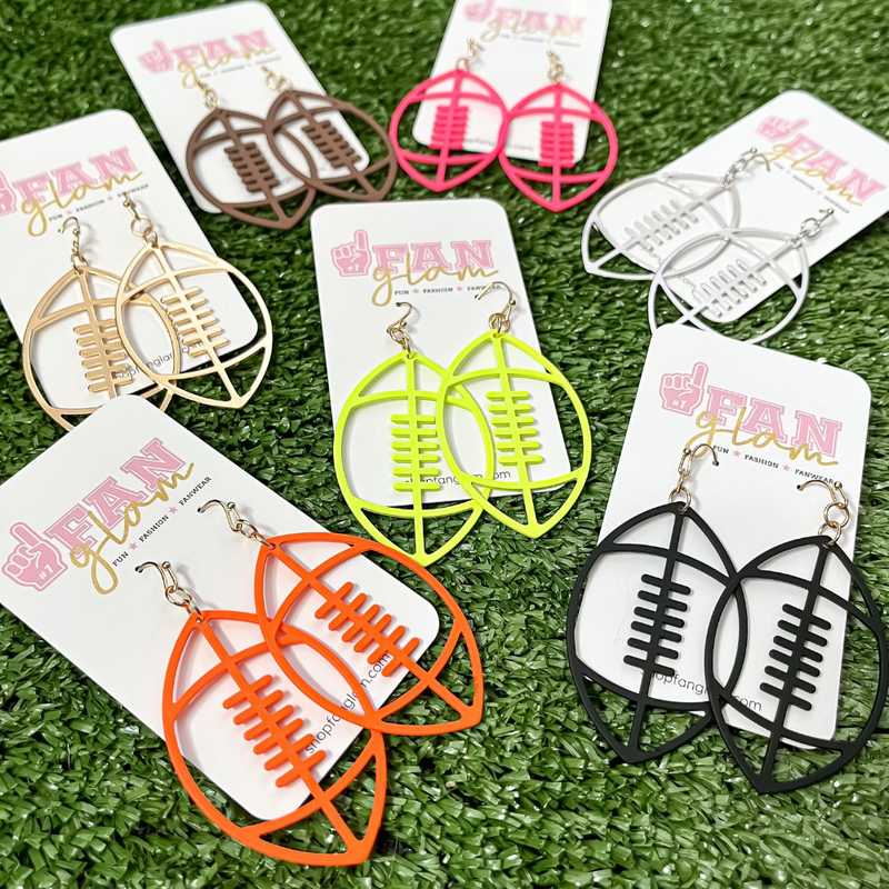 It's time to get ready for kick-off!  Show off your football fan status by accessorizing your Game Day look with our Touchdown Football Drop Earrings.     Available in 7 versatile color ways you can mix and match with all your stadium looks!