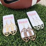 It's time to get ready for kick-off!  Show off your football fan status by accessorizing your Game Day look with our Touchdown Football Drop Earrings.     Available in 7 versatile color ways you can mix and match with all your stadium looks!